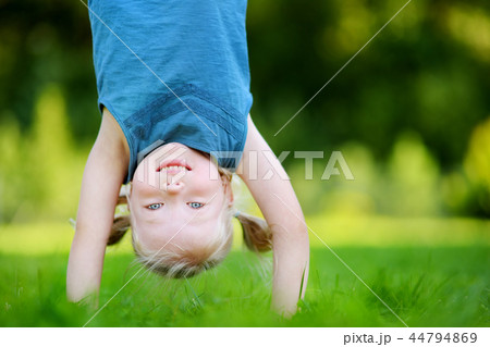 Happy young child playing head over heels Happy young child playing head over heels 44794869
