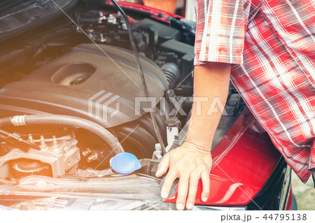 Hand of auto mechanic with a wrench 44795138