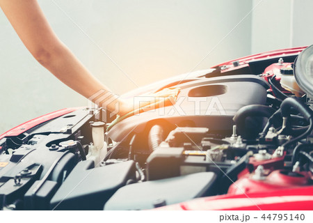 Woman wiping car engine for new vehicle 44795140