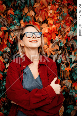 Beautiful girl in red shirt in a park Beautiful girl in red shirt in a park 44796128