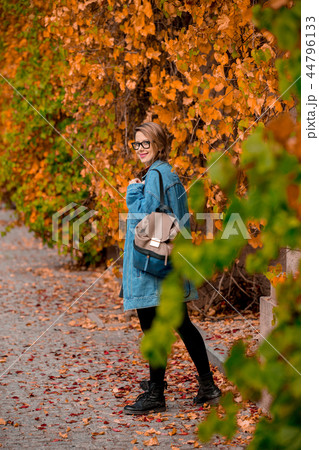 girl in glasses and jacket in a autumn season park. girl in glasses and jacket in a autumn season park. 44796133