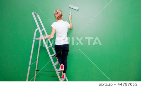 woman with paint roller and ladder in own house woman with paint roller and ladder in own house 44797055