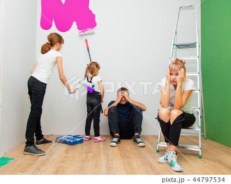 parents and children are paint a new room 44797534