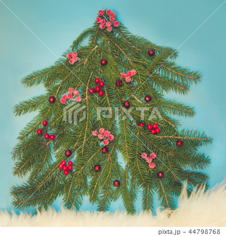 Christmas tree maked of spruce branch on blue. Christmas tree maked of spruce branch on blue. 44798768