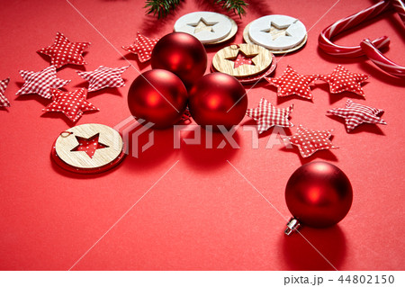 christmas baubles, stars and decorations on a red background christmas baubles, stars and decorations on a red background 44802150