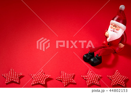 santa claus figurine on a red background 44802153