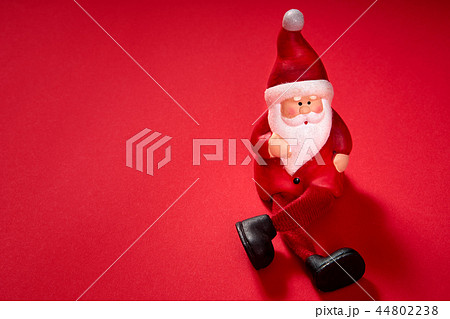 santa claus figurine on a red background 44802238