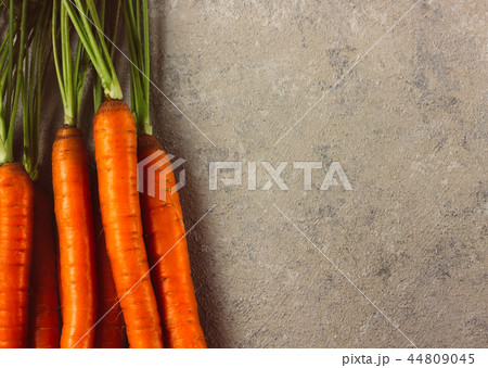 Raw whole fresh carrots on gray background. 44809045