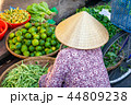 A senior woman sells fruits and vegetables 44809238