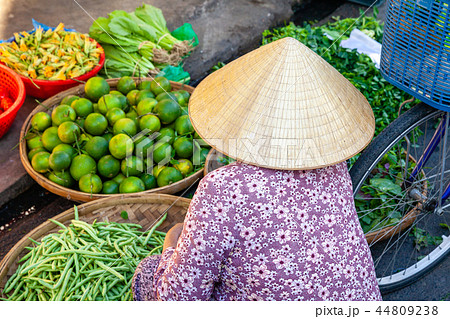A senior woman sells fruits and vegetables 44809238