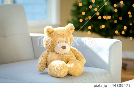Teddy bear on a couch around Christmas Teddy bear on a couch around Christmas 44809475