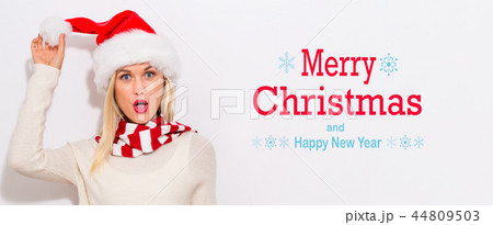 Merry Christmas and Happy New Year message with woman with Santa hat Merry Christmas and Happy New Year message with woman with Santa hat 44809503
