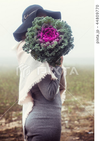 The woman covered her face with cabbage The woman covered her face with cabbage 44809770
