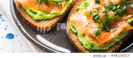 Rye bread avocado toasts with smoked salmon 44810037
