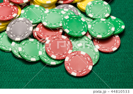 Casino chips on green table 44810533