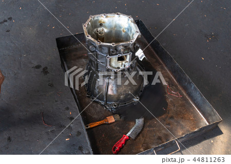 Old engine repairers in the garage. 44811263