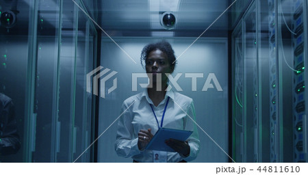 Black woman with tablet working in server room Black woman with tablet working in server room 44811610