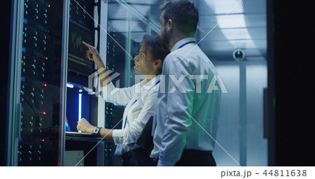 IT engineers with devices coworking in data center IT engineers with devices coworking in data center 44811638