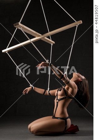 Woman in the image of marionette in the dark Woman in the image of marionette in the dark 44819507