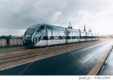 Modern city tram crossing bridge after rain Modern city tram crossing bridge after rain 44821994