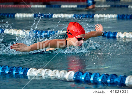 Female athlete swims with a butterfly style Female athlete swims with a butterfly style 44823032