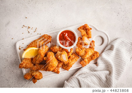 Fried Breaded chicken with tomato sauce  44823808