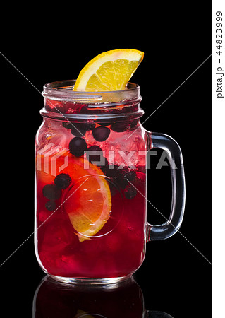 Cocktail with currant and vodka in mason jar mug 44823999
