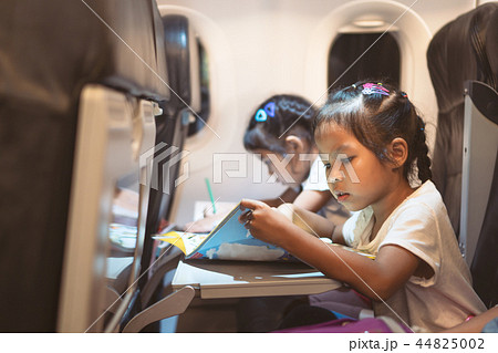 Cute asian child girls traveling by an airplane 44825002