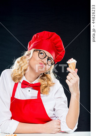 Thoughtful crazy cook posing with cream ice cream 44826233