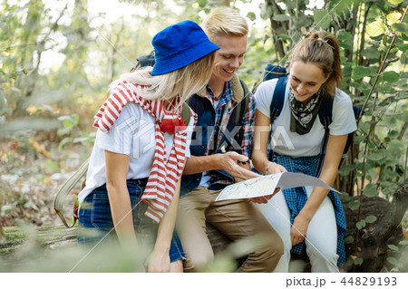 Group of friends watching the route in the traveler map on hiking Group of friends watching the route in the traveler map on hiking 44829193
