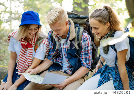Group of friends watching the route in the traveler map on hiking Group of friends watching the route in the traveler map on hiking 44829201