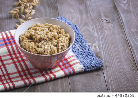 Oatmeal in a plate. Napkin. Nuts Berries. Honey 44830259