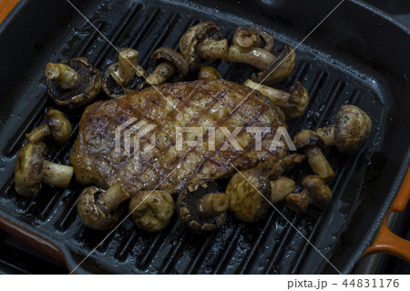 Cooking steak and mushrooms on the grill pan Cooking steak and mushrooms on the grill pan 44831176
