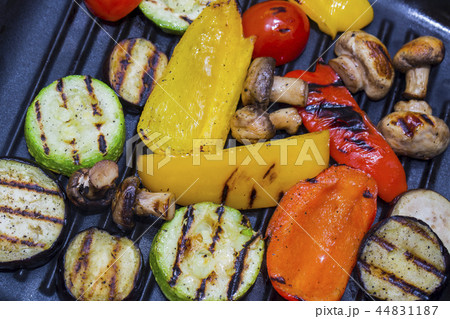 Cooking vegetables and mushrooms on grill pan  44831187