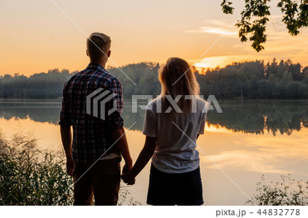 Couple holding hands at sunset Couple holding hands at sunset 44832778