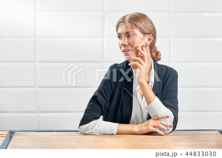 Front view of attractive woman looking aside and posing with new manicure. 44833030