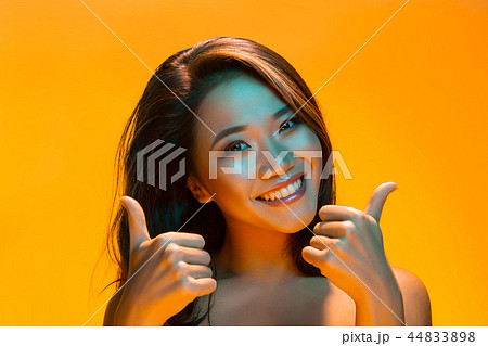 High Fashion model woman in colorful bright lights posing in studio 44833898