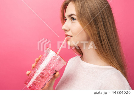 Portrait of beautiful young woman drinking fizzy Portrait of beautiful young woman drinking fizzy 44834020