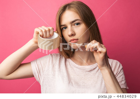 Young girl on pink background Holding Young girl on pink background Holding 44834029