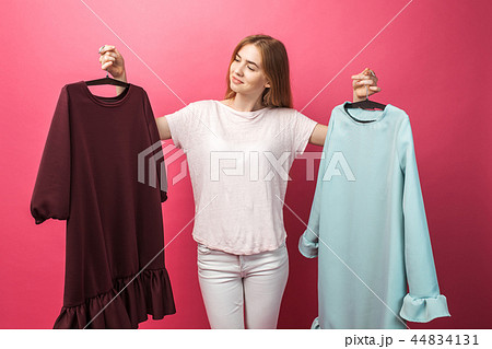 Portrait of a beautiful young girl chooses a dress 44834131