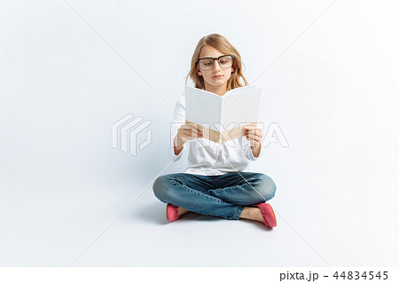 Little modern girl with glasses reading Little modern girl with glasses reading 44834545
