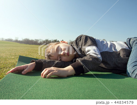 Boy sleep outdoors in the autumn park Boy sleep outdoors in the autumn park 44834579