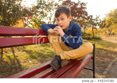 Boy sitting on the bench Boy sitting on the bench 44834580