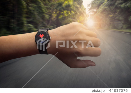 runner checking at heart rate monitor smart watch 44837076
