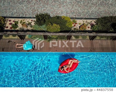 Woman is swimming on an inflatable lounger 44837550