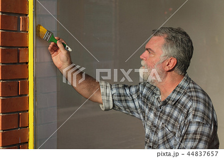 Old shop renovation, worker painting window Old shop renovation, worker painting window 44837657