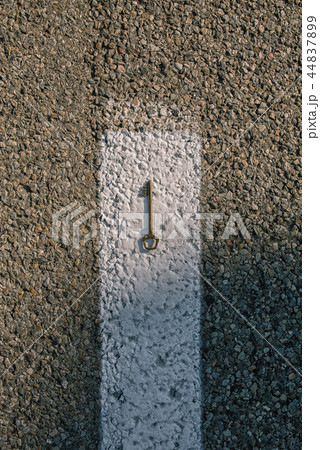 Old vintage brass door Key on asphalt road Old vintage brass door Key on asphalt road 44837899