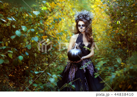 Portrait of a young woman with makeup for Halloween. Portrait of a young woman with makeup for Halloween. 44838410