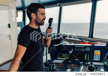 Marine navigational officer is reporting by VHF radio 44839855
