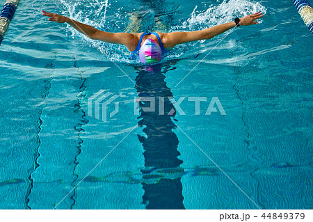 Female athlete swims with a butterfly style. Female athlete swims with a butterfly style. 44849379